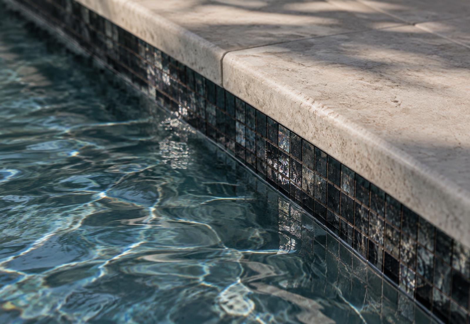 Waterline tile meeting stone coping