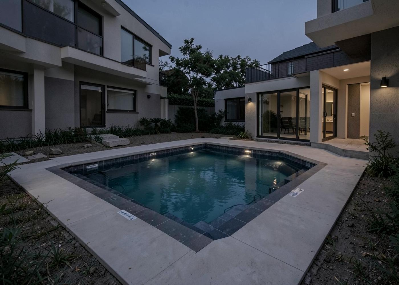 New pool with integrated spa and evening lighting